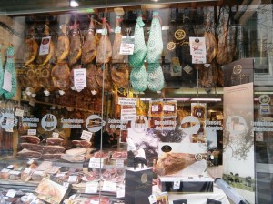 A typical delicatessen in Spain offers whole or cut cured hams and many varieties of cheese.