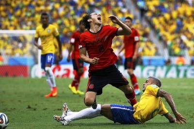 Mexico's Andres Guardado is fouled by Brazil's Daniel Alves. Photo credit:  Sydney Morning Herald, Australia